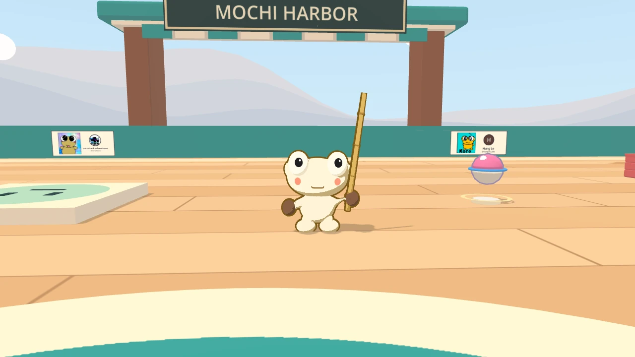 Kero stands on the quay of Mochi Harbor under the big MOCHI HARBOR gate. Two small panels with drawings hang on the seawall behind him, one on each side.