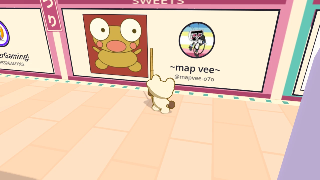 Kero stands under ~map vee~’s panel in the west back lane. It holds a drawing of Kero on a red background, and beside it the artist’s round picture, the name ~map vee~ and @mapvee-o7o.